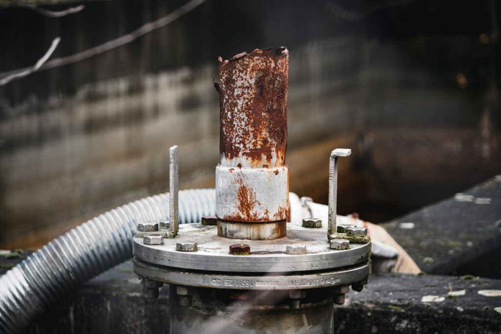 Rusted metal on a machine, showing the corrosion that protective plating and testing aim to prevent